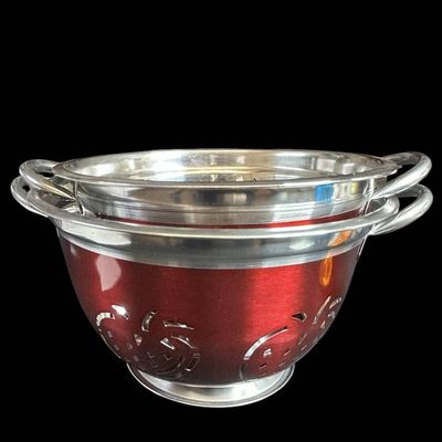 Sale Photo Thumbnail #995:  Two Stainless Steel Colanders with Red Exterior and Apple Cutout Design.                           