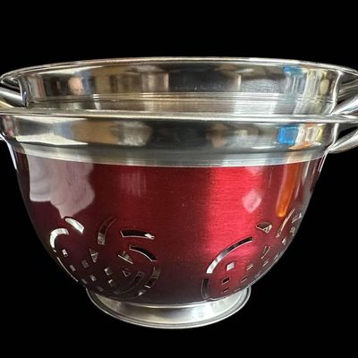 Sale Photo Thumbnail #998:  Two Stainless Steel Colanders with Red Exterior and Apple Cutout Design.                           