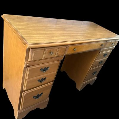 Sale Photo Thumbnail #1074: 30 X 44 X 17.50 Traditional Maple Double Pedestal Executive Kneehole Desk  features 7 drawers total with center pencil drawer flanked by storage drawers and deep lower file drawers  molded top border  scalloped apron base  and brass drop-pull hardware. 30