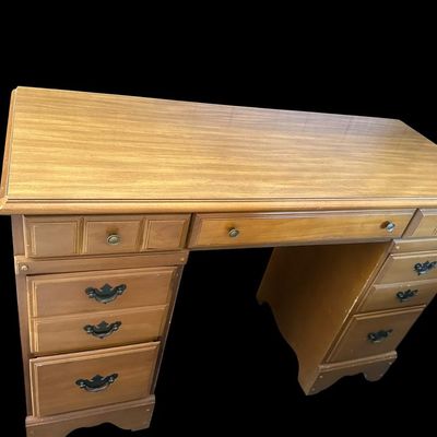 Sale Photo Thumbnail #1072: 30 X 44 X 17.50 Traditional Maple Double Pedestal Executive Kneehole Desk  features 7 drawers total with center pencil drawer flanked by storage drawers and deep lower file drawers  molded top border  scalloped apron base  and brass drop-pull hardware. 30