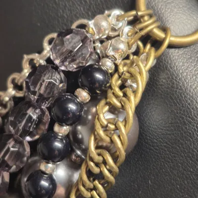 Sale Photo Thumbnail #115: The image shows a multi-strand statement necklace that appears to be the "Main Event" necklace by Premier Designs, featuring layered strands of black beads, gray faux pearls, and metallic chain