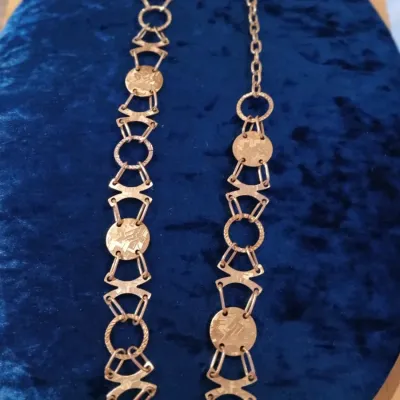 Sale Photo Thumbnail #180: Gold tone Chain Belt The Silver Chain Belt is a stylish accessory for women, featuring a 40" long chain with a normal belt width. Made of metal in a sleek silver color, this adjustable chain belt adds a touch of elegance to any outfit. With silver hardwar