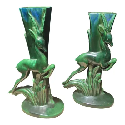 Sale Photo Thumbnail #210: Pair of Royal Haeger MCM Gazelle Vases w/ green and Iris blue drip glaze.In great shape, no cracks or major chips. A small flea bites on bottoms of both....not noticable

Green and blue drip glaze vibrant under white light.

The vase measures 15 3/8" tall