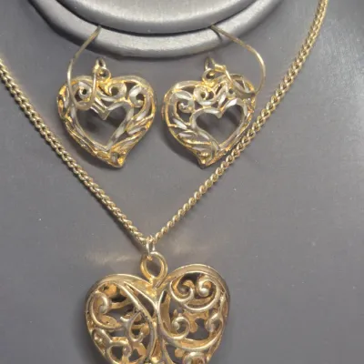 Sale Photo Thumbnail #229: Filigree Heart Pendant on chain link gold tone chain w/ lobster closure
> pendant is 1.5" dia.  chain is 16" long
> pendant is open filigree both sides.............unbranded
Sterling silver Heart shaped Earrings ~ marked sterling reverse side
>1.25" total