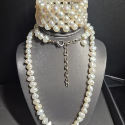 Sale Photo Thumbnail #294: Vintage Single Strand 80 Cultured Pearl Hand-Knotted  & expandable Bracelet
Necklace is a single strand of 80 irregular cultured pearls.  Size:  14" 
Bracelet is expandable.....unbranded
Size: 3" / 5" dia