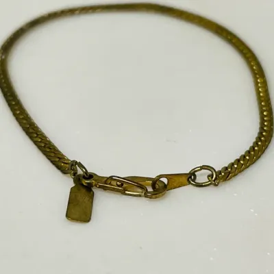 Sale Photo Thumbnail #89: Add a touch of classic shine with this 14K Gold Filled twisted herringbone chain bracelet finished with a secure lobster clasp.

Stamped 14K GF
7”
3.0 grams tw
bracelet will be cleaned and toned to luster