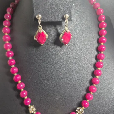 Sale Photo Thumbnail #35: This is a bright pink/magenta beaded necklace and matching earring set featuring vibrant round beads, silver-tone diamond-shaped drop earrings with matching stones, and accent beads
> second earring set is a butterfly w/rhinestones.....for that Fun Evenin