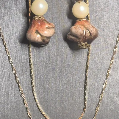 Sale Photo Thumbnail #18: Natural Agate / Rhodite Pendant on 14k ITALY gold chain & Earrings + Bracelet
The image shows a natural agate gemstone pendant with a smooth, polished surface and a banded pink or reddish stripe
.< Necklace is 14K marked Italy. 18" long full length w/ lob