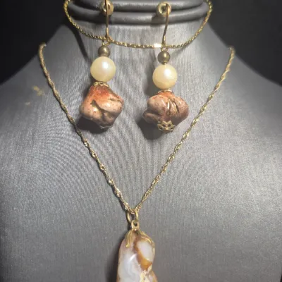 Sale Photo Thumbnail #17: Natural Agate / Rhodite Pendant on 14k ITALY gold chain & Earrings + Bracelet
The image shows a natural agate gemstone pendant with a smooth, polished surface and a banded pink or reddish stripe
.< Necklace is 14K marked Italy. 18" long full length w/ lob