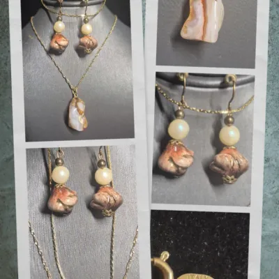 Sale Photo Thumbnail #16: Natural Agate / Rhodite Pendant on 14k ITALY gold chain & Earrings + Bracelet
The image shows a natural agate gemstone pendant with a smooth, polished surface and a banded pink or reddish stripe
.< Necklace is 14K marked Italy. 18" long full length w/ lob