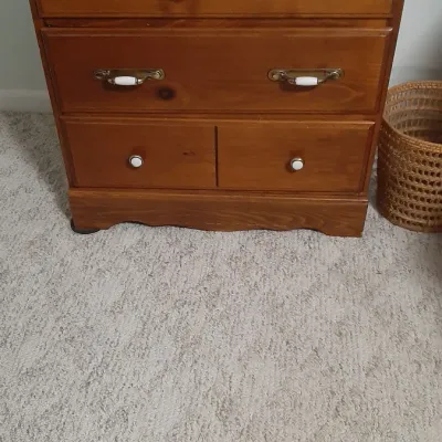 Traditional pine wood dresser featuring two wide drawers with brass and ceramic bail pulls above two smaller lower drawers with ceramic...