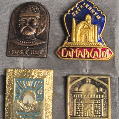 Sale Photo Thumbnail #30: a collection of vintage Soviet-era souvenir lapel pins and badges (made in the USSR), featuring historical and architectural landmarks:

• Top Left: A bronze-toned commemorative badge depicting Alexander Nevsky (Александр Невский).
• T