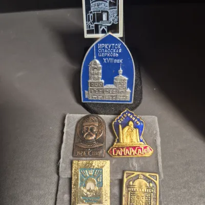 Sale Photo Thumbnail #32: a collection of vintage Soviet-era souvenir lapel pins and badges (made in the USSR), featuring historical and architectural landmarks:

• Top Left: A bronze-toned commemorative badge depicting Alexander Nevsky (Александр Невский).
• T