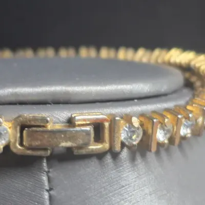 Sale Photo Thumbnail #84: Vintage gold tone Tennis Bracelet ~ Cz stones & MCM design
> each stone is housed in a square bumper bracelet [bar set]
> round stones give a continuous line of clear faceted CZ stones
> excellent condition / snap clasp / 7.5" long