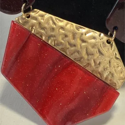 Sale Photo Thumbnail #36: This is a chunky statement necklace featuring red and dark maroon resin or acryl beads paired with textured, hammered gold-tone metallic plates.
Designed for impact and BRUTALIST design.....overall 16" wi/ lobster clasp
Earrings are match and 925 sterling