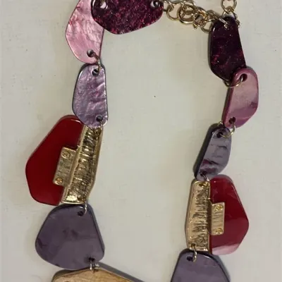 Sale Photo Thumbnail #43: This is a chunky statement necklace featuring red and dark maroon resin or acryl beads paired with textured, hammered gold-tone metallic plates.
Designed for impact and BRUTALIST design.....overall 16" wi/ lobster clasp
Earrings are match and 925 sterling