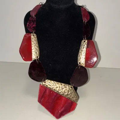 Sale Photo Thumbnail #42: This is a chunky statement necklace featuring red and dark maroon resin or acryl beads paired with textured, hammered gold-tone metallic plates.
Designed for impact and BRUTALIST design.....overall 16" wi/ lobster clasp
Earrings are match and 925 sterling