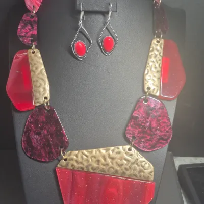 Sale Photo Thumbnail #35: This is a chunky statement necklace featuring red and dark maroon resin or acryl beads paired with textured, hammered gold-tone metallic plates.
Designed for impact and BRUTALIST design.....overall 16" wi/ lobster clasp
Earrings are match and 925 sterling