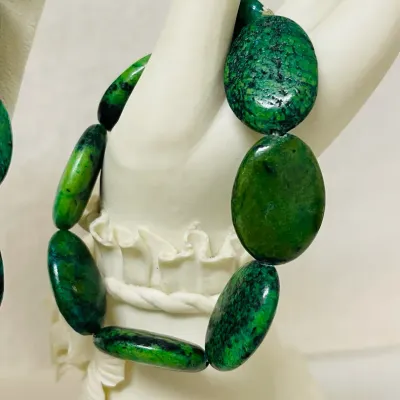Sale Photo Thumbnail #243: Make a bold statement with this striking Chrysocolla Gemstone Jewelry Set, featuring a 40” long Necklace and coordinating Stretch Bracelet crafted with heavy polished oval Stones in vivid blue-green, emerald and deep black natural matrix patterns.