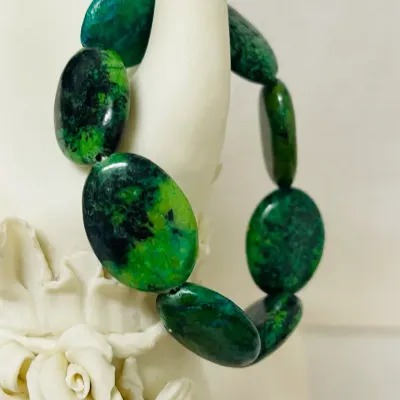 Sale Photo Thumbnail #242: Make a bold statement with this striking Chrysocolla Gemstone Jewelry Set, featuring a 40” long Necklace and coordinating Stretch Bracelet crafted with heavy polished oval Stones in vivid blue-green, emerald and deep black natural matrix patterns.
