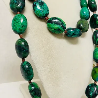 Sale Photo Thumbnail #244: Make a bold statement with this striking Chrysocolla Gemstone Jewelry Set, featuring a 40” long Necklace and coordinating Stretch Bracelet crafted with heavy polished oval Stones in vivid blue-green, emerald and deep black natural matrix patterns.
