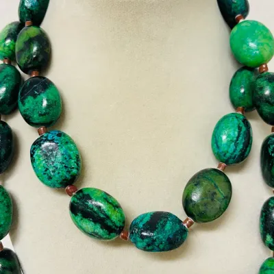 Sale Photo Thumbnail #246: Make a bold statement with this striking Chrysocolla Gemstone Jewelry Set, featuring a 40” long Necklace and coordinating Stretch Bracelet crafted with heavy polished oval Stones in vivid blue-green, emerald and deep black natural matrix patterns.