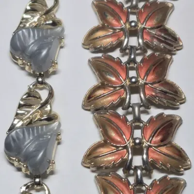 Sale Photo Thumbnail #249: Pair MCM Bracelets ~ Lucite Thermo & Thermoset Butterfly-leaf 
> blue lucite thermoset plastic leaf w/gold foundation and snap click clasp
> coral pink thermoset butterfly design
both great MCM designs