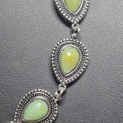 Sale Photo Thumbnail #89: Silvertone marcasite jewelry set includes a necklace, and earrings featuring aventurine stones. The pieces are adorned with marcasite stones, giving them a unique and stylish look.  Lobster clasp and 3" extenetion
Earrings marked 925 on pierced loops
