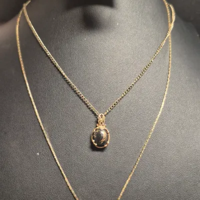 Sale Photo Thumbnail #262: Vintage Gold tone Set ~ 2 Necklaces & 2 Fashion Brooches
> necklace marked STC Karis w/ black n gold flake stone
> necklace with elongated pendant is 18" long w/lobster clasp
> 2 brooches .....pin perfect 
all in Vg condition