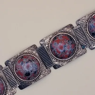Sale Photo Thumbnail #271: This Vintage Natural Patina Copper & Red Confetti Lucite Cabochon Panel Bracelet features a unique design with simulated red cabochon stones set in copper. Measuring 7 inches in length,
excellent condition, cleaned and toned to luster