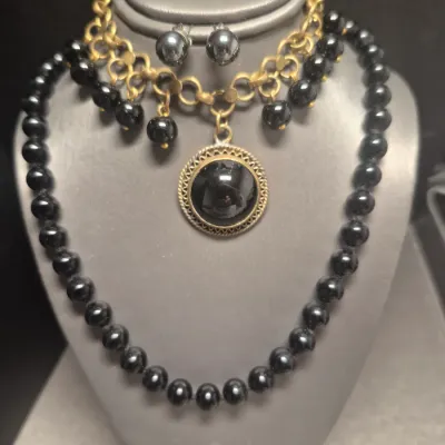 Sale Photo Thumbnail #130: Vintage dangling large Black Cabochon glass stone and dangling black beads on a 8" brass-tone chain bracelet.
> Monet marked 15" glass bead necklace w/ lobster clasp
> pair of stuff earring to coordinate