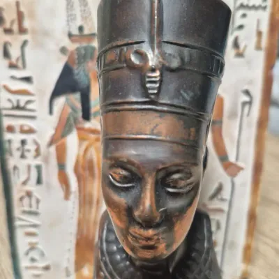 Sale Photo Thumbnail #202: Vintage Egyptian Revival Nefertiti ~ metal bronzed  bust statue w/Decorative tile
>cast metal w/bronzed patina finish
> base embossed winged eagle / falcon relief
> condition: beautiful vintage condition, no cracks breaks or structural damage....felt base