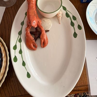 Ceramic lobster-themed oval serving platter with an attached dip bowl, sculpted starfish, and seashell accents.