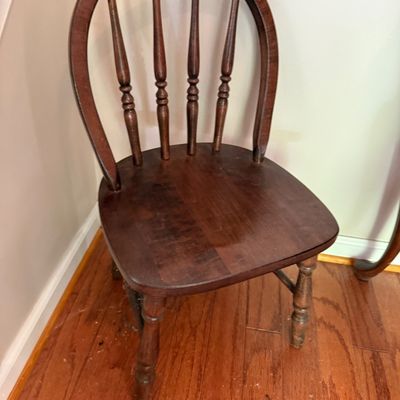 Vintage dark stain wooden hoop-back dining chair featuring turned spindles and legs.