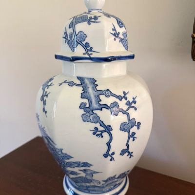 Chinese blue and white porcelain ginger jar with lid, featuring cherry blossom and bird motifs.