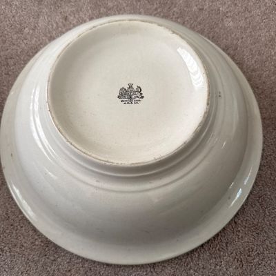 Underside of an antique white ironstone wash basin bowl featuring a J. & G. Meakin maker's mark.