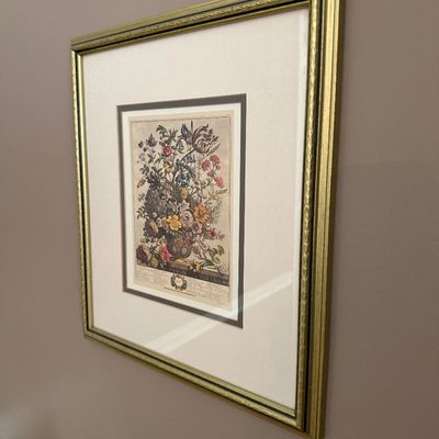 Framed botanical floral print depicting a vase of flowers, double-matted in a molded gold frame.