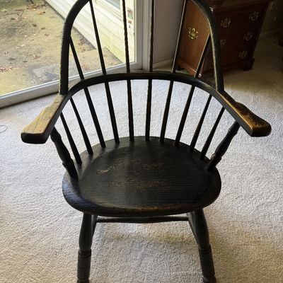 Vintage Windsor-style sack-back armchair in a distressed black-painted finish.