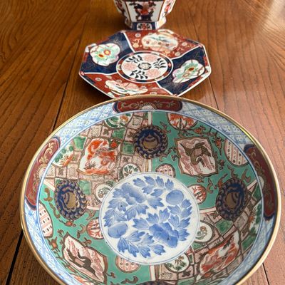 Set of three vintage Imari-style porcelain pieces, including a large round serving bowl, an octagonal plate, and an octagonal footed...