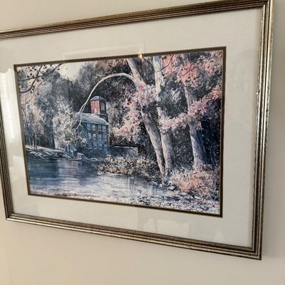 Framed landscape art print featuring a historic mill by a river, presented with a wide white mat and silver-tone frame.