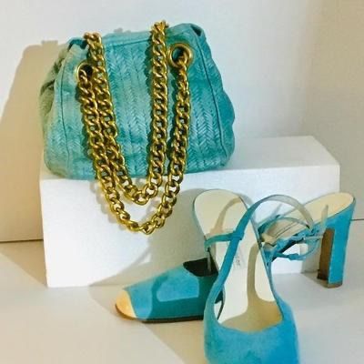 Vintage turquoise woven leather handbag with chunky gold-tone chain straps, paired with matching turquoise suede block-heel pumps.