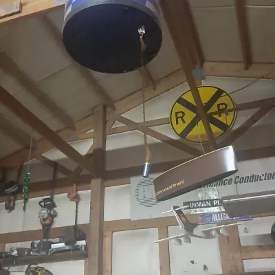 Large hanging Red Bull can promotional display cooler mounted to wooden ceiling rafters.