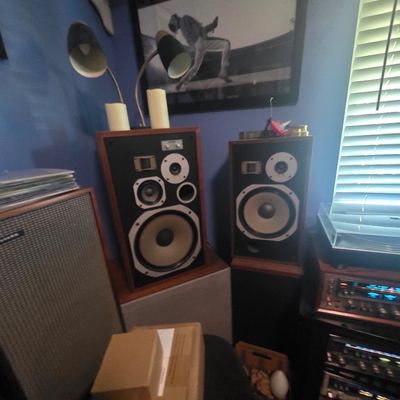Sale Photo Thumbnail #21: Pair of vintage Pioneer HPM-series floor-standing speakers with wood cabinets, set alongside additional audio equipment and a two-head gooseneck lamp.