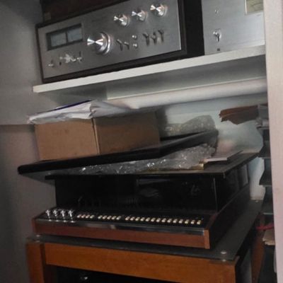 Sale Photo Thumbnail #31: A shelf unit and closet filled with vintage audio equipment, including a silver-face stereo receiver, turntable, and an office printer below.