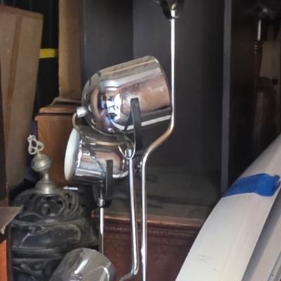 Sale Photo Thumbnail #37: Mid-century modern chrome multi-head spotlight floor lamp stored alongside miscellaneous household items.
