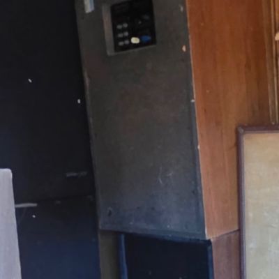 Sale Photo Thumbnail #42: Vintage wood-grained floor-standing audio speakers stacked in a storage space, showing rear connection panels.
