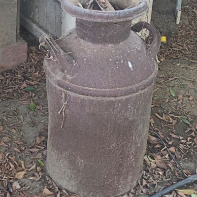 Sale Photo Thumbnail #44: Rustic vintage metal milk can with dual handles and heavy surface patina.