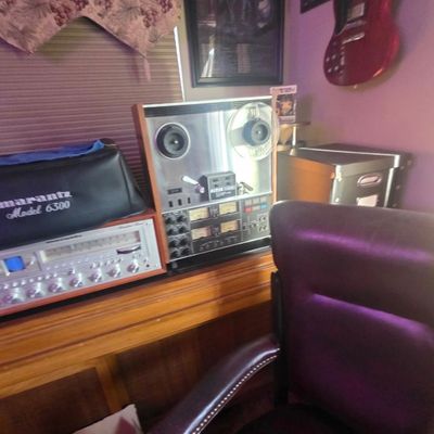 Sale Photo Thumbnail #51: Vintage audio equipment setup including a Marantz receiver with its dust cover and a Teac reel-to-reel tape deck mounted on a wooden desk.