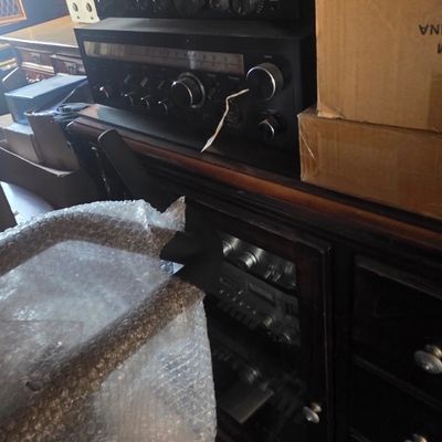 Sale Photo Thumbnail #56: Stack of vintage stereo audio components, including receivers and amplifiers, sitting on a dark wood media console.