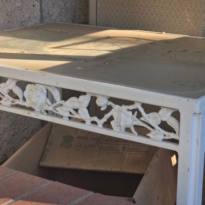 Sale Photo Thumbnail #77: Vintage white wrought metal patio side table featuring an ornate rose and leaf filigree apron.